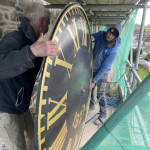Clock face being lifted into position