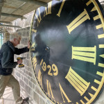 Clock face being screwed into position