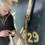 Application of marine grease to clock hands
